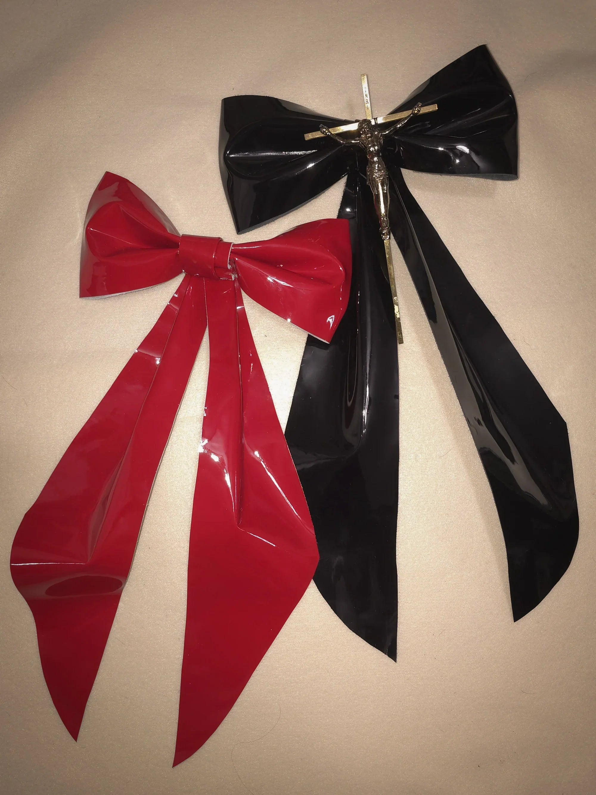 black and red large patent leather bows on cream background