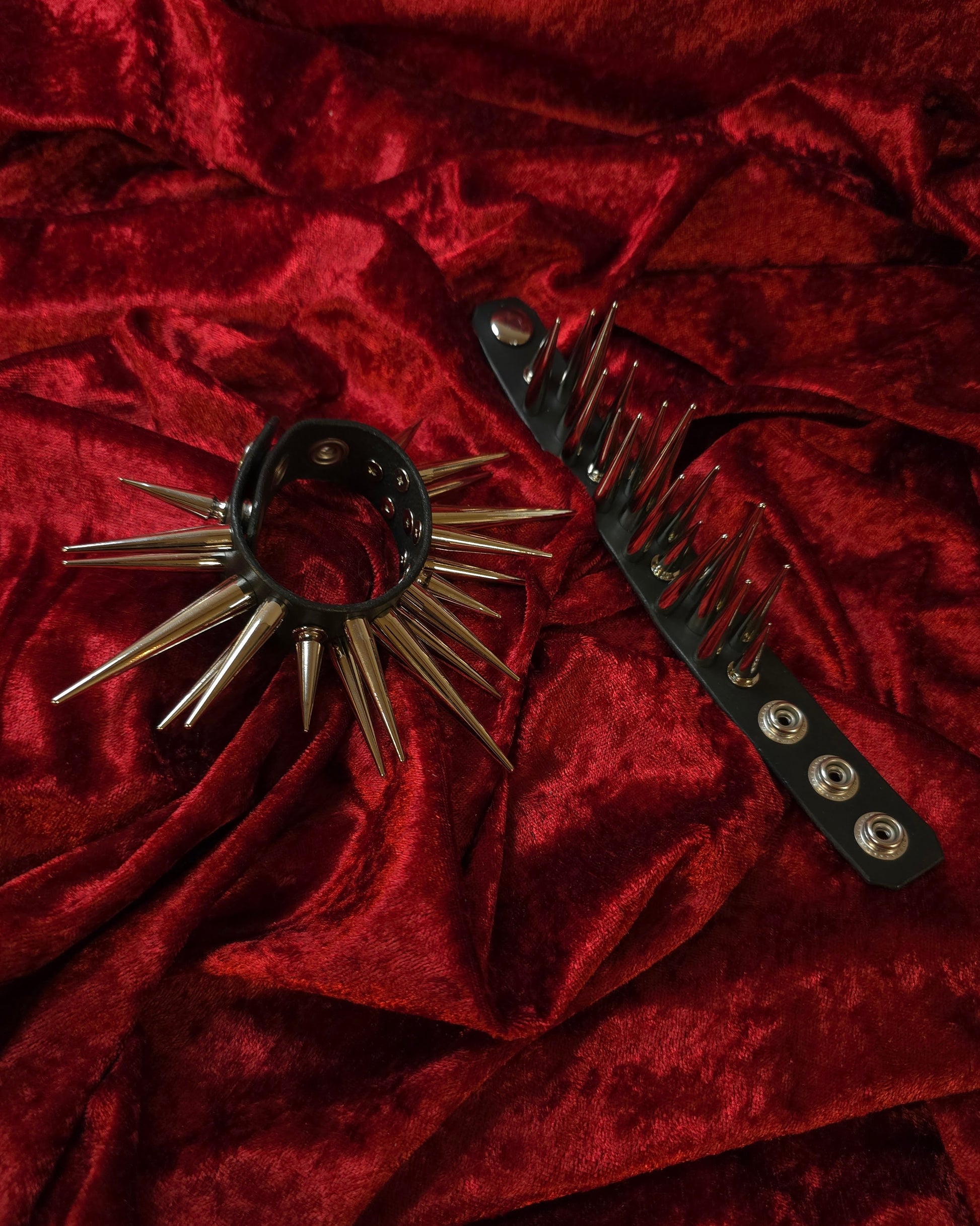 Spiked cuff on a red textured fabric background