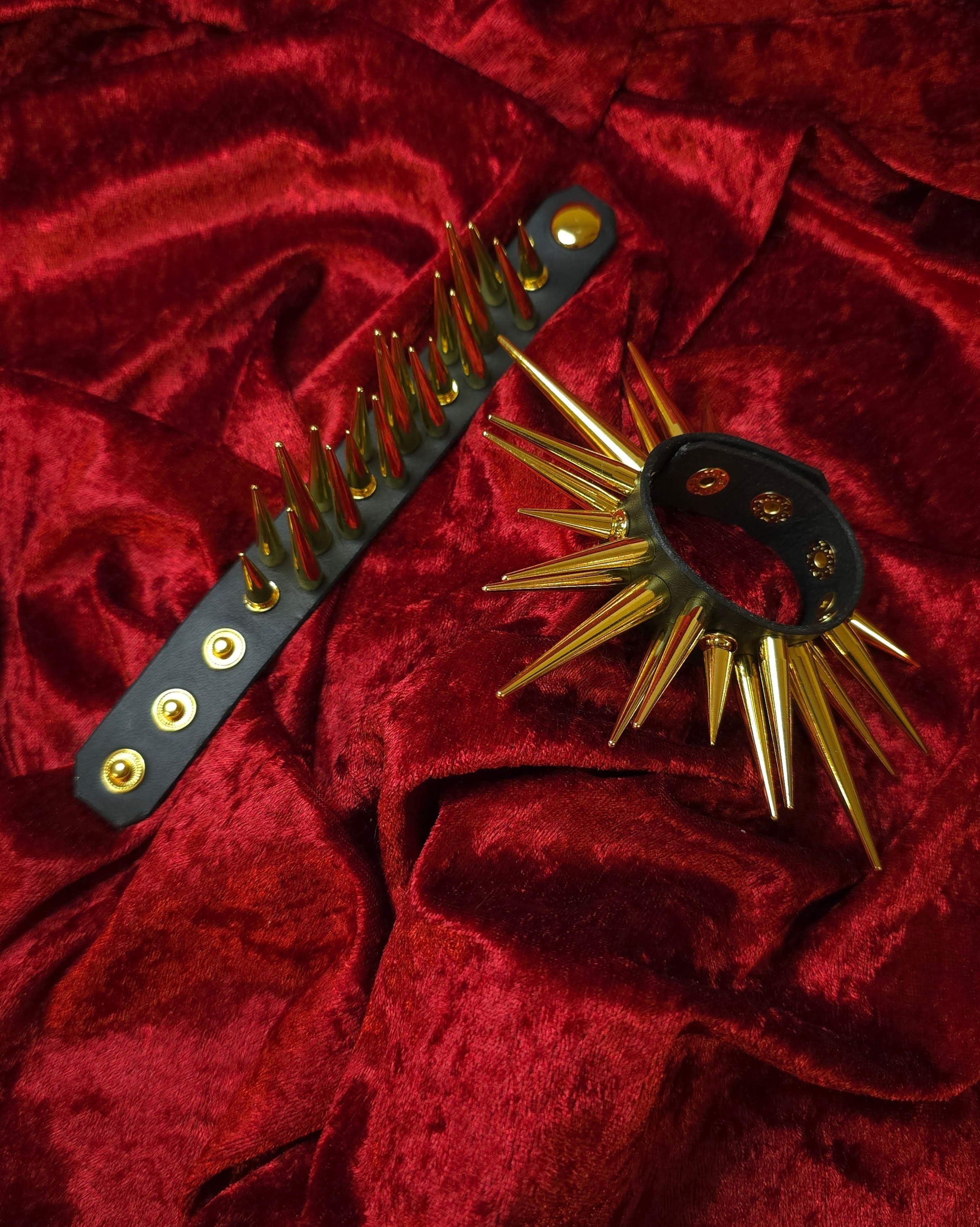 Spiked leather accessory on a red textured background