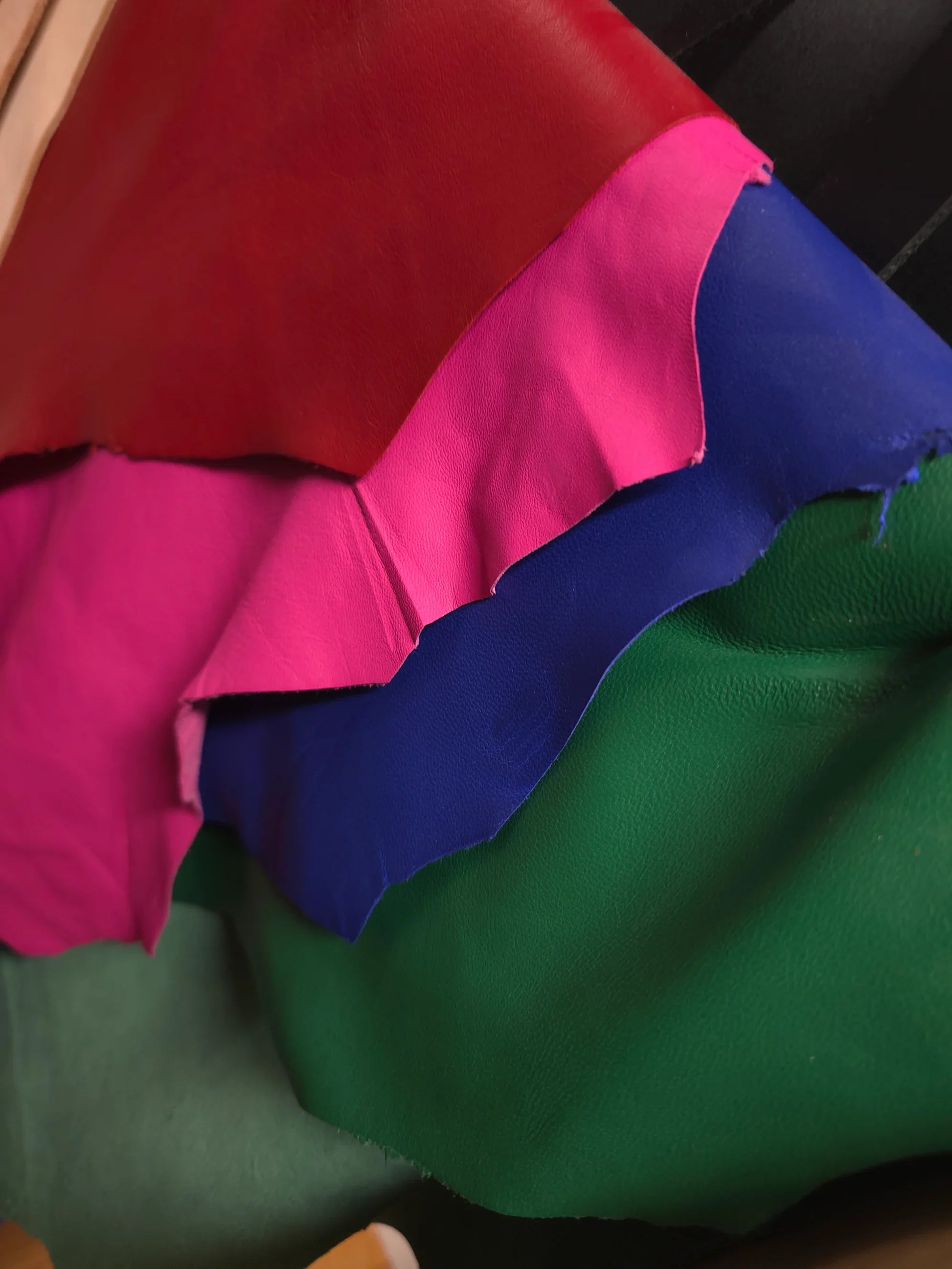 image of red, pink, blue, green leather