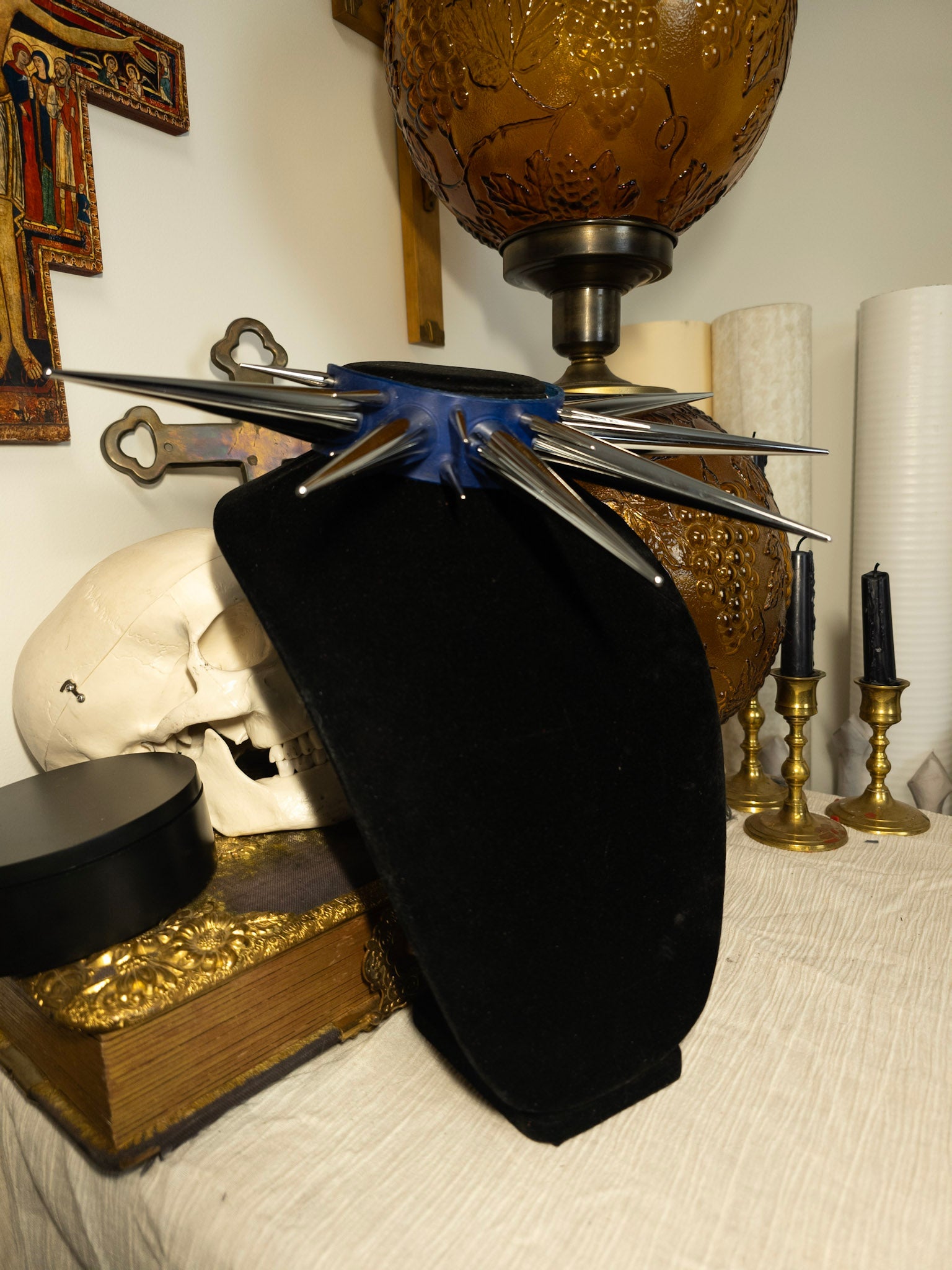 blue and silver collar on black necklace stand with gothic decor