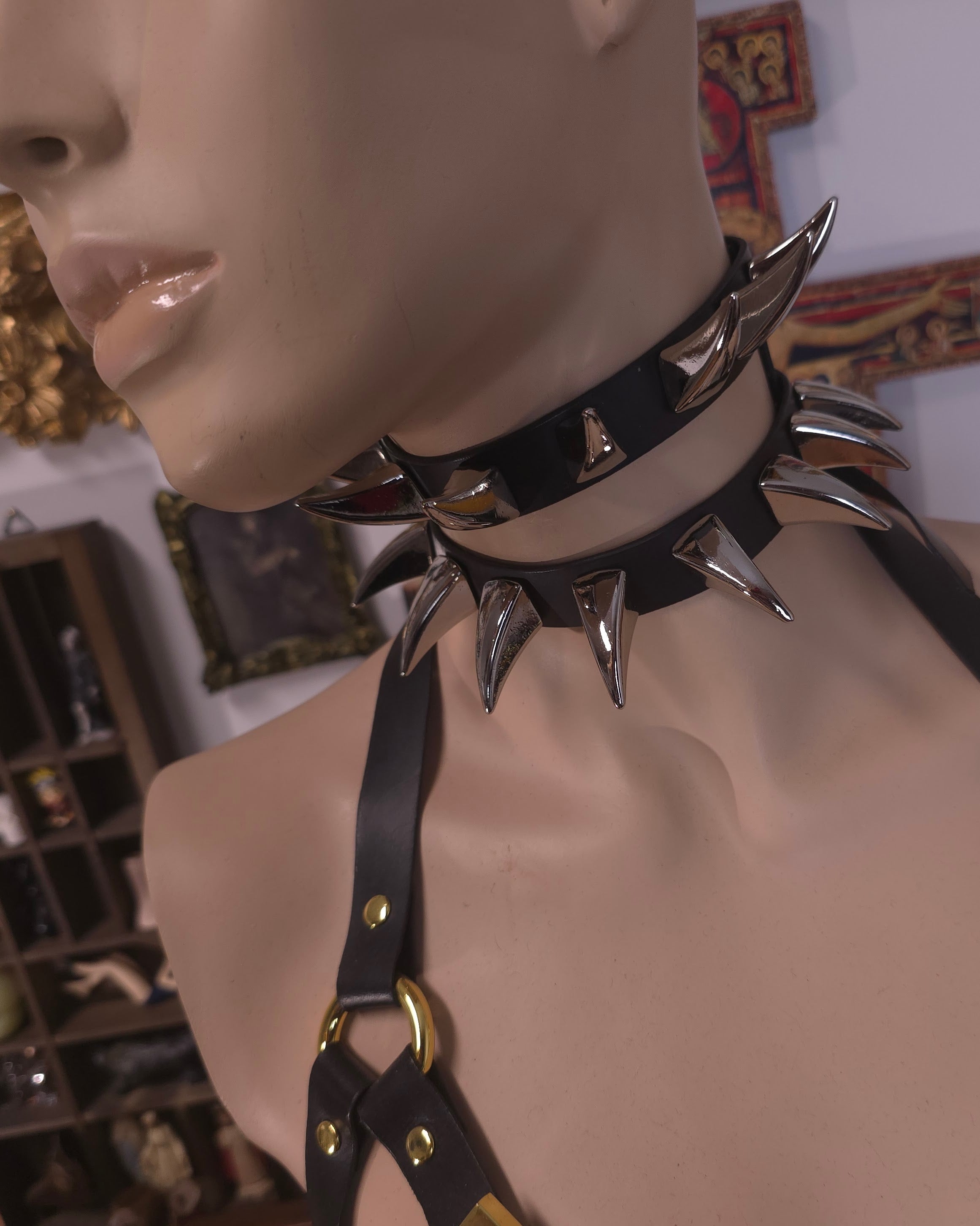 mannequin wearing black leather with golden spike collar