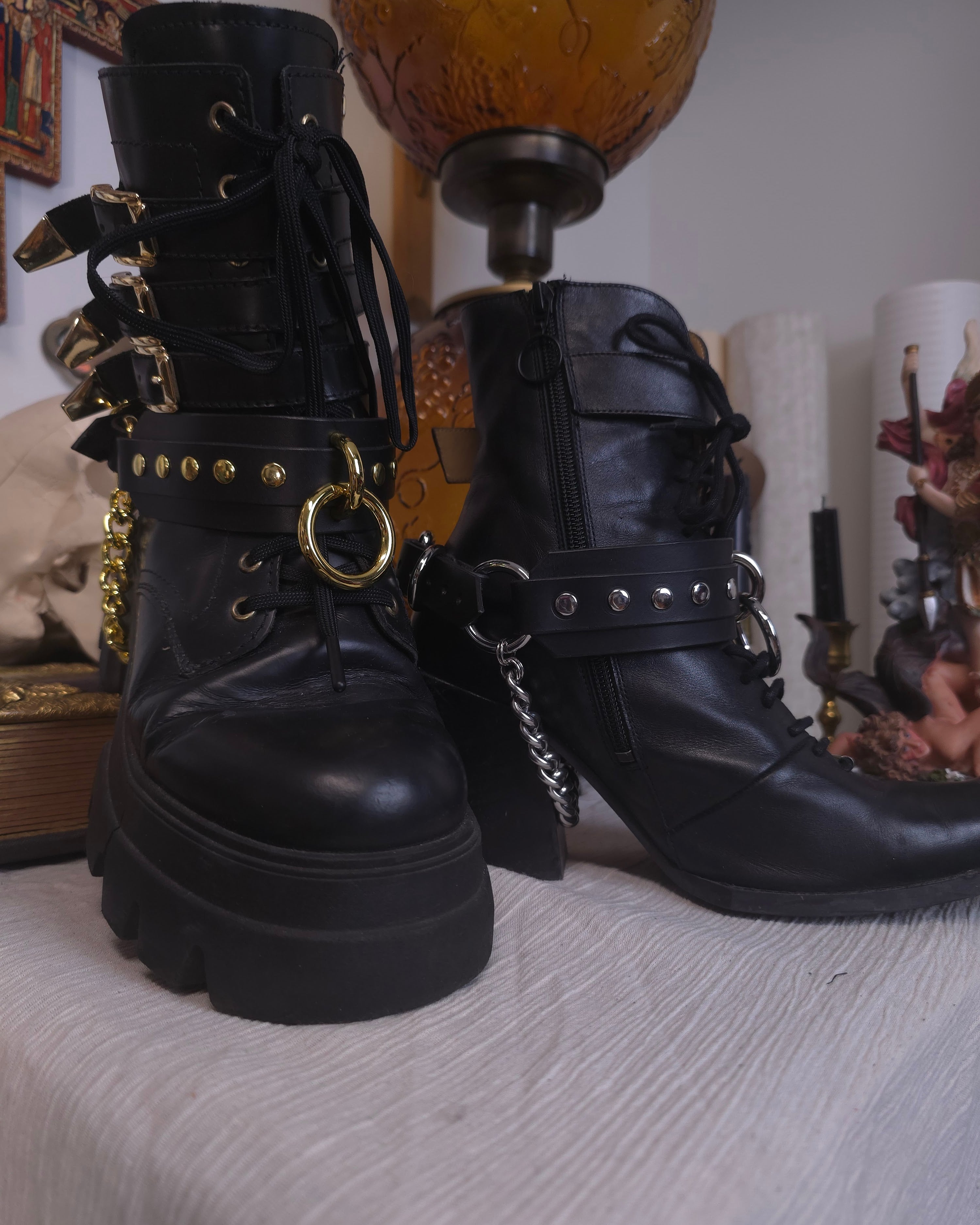 black boots with leather belts with silver and golden studs
