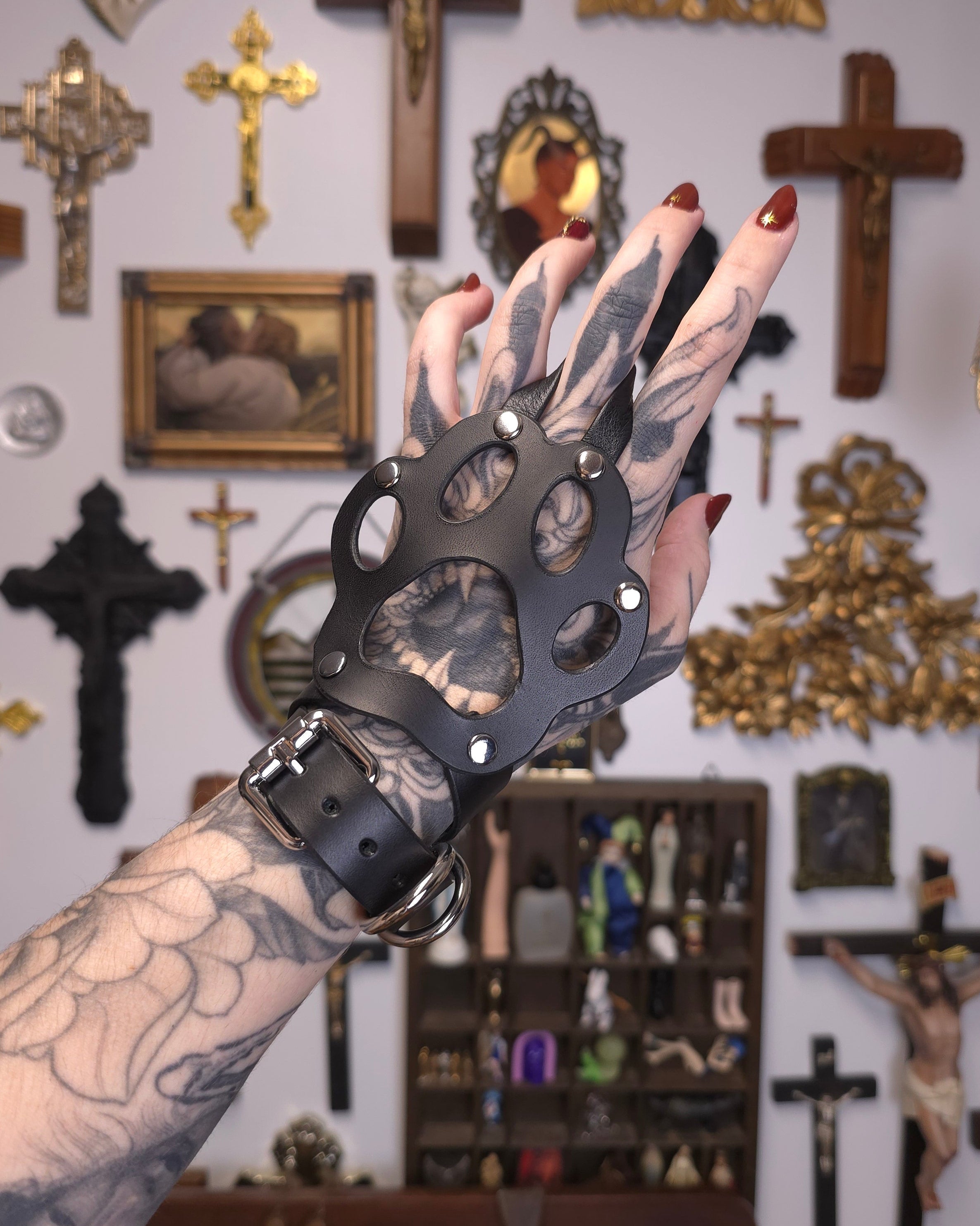 hand wearing leather paw