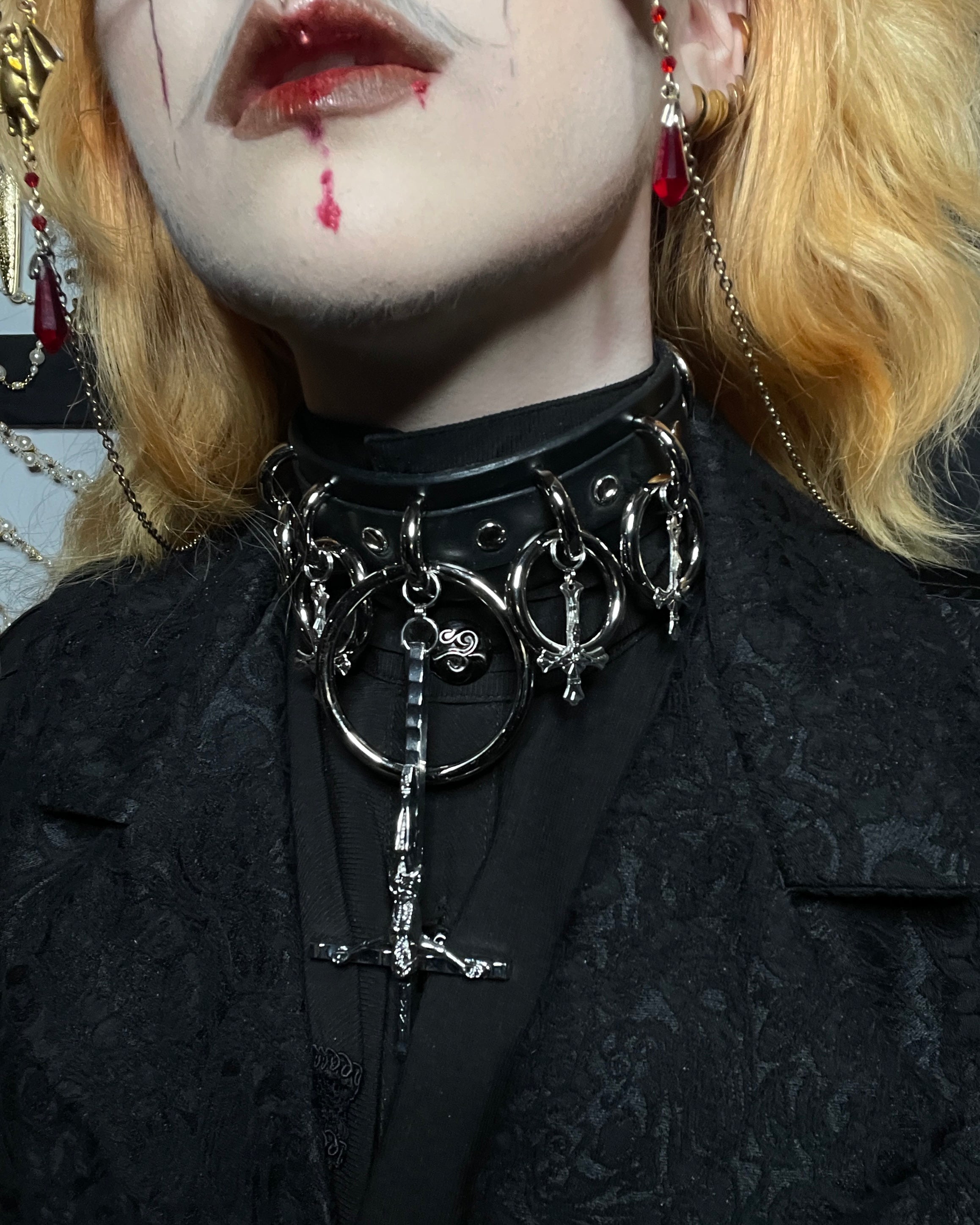 person wearing black and silver choker with inverted cross