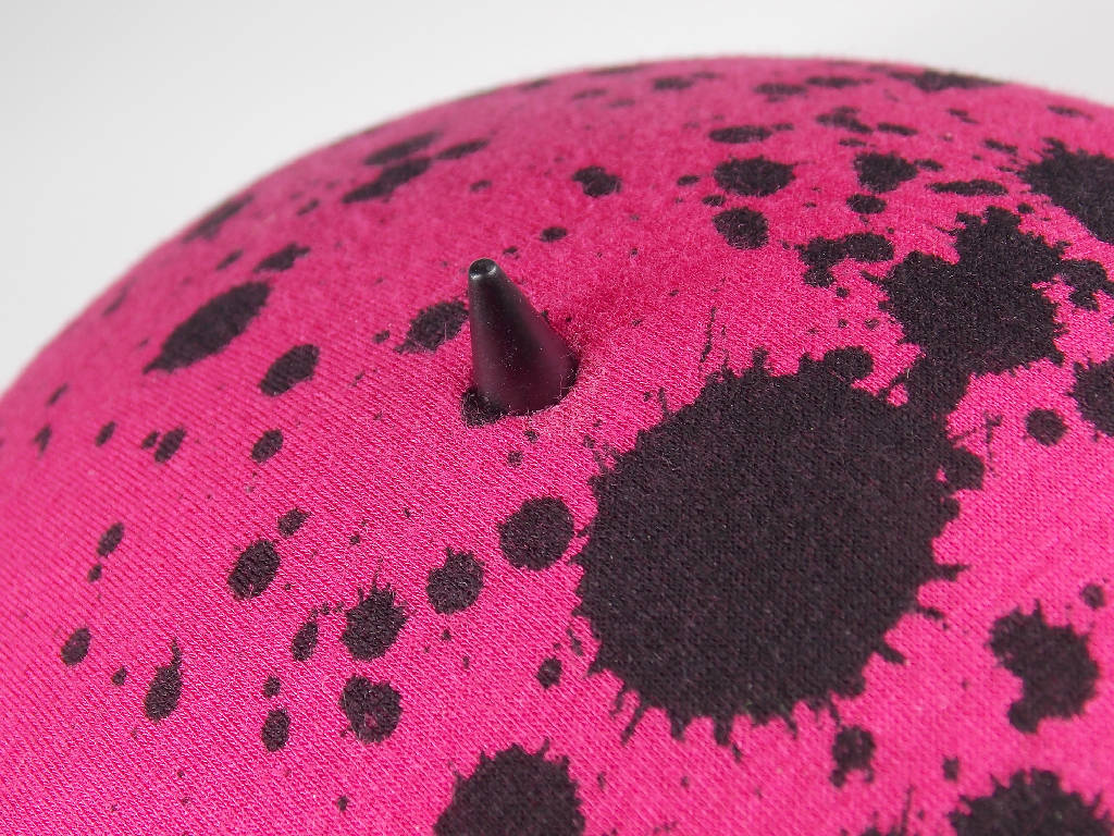 Pink mini hat with splatter design and spike